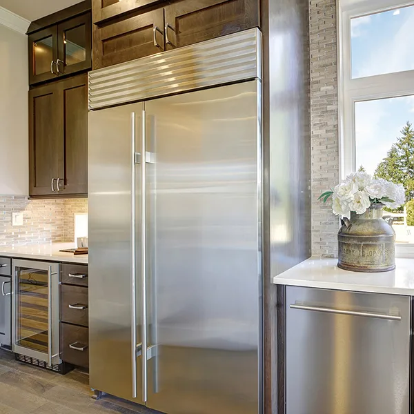 Professional Sub-Zero appliance repair technician servicing refrigerator in Greenwood Village Colorado
